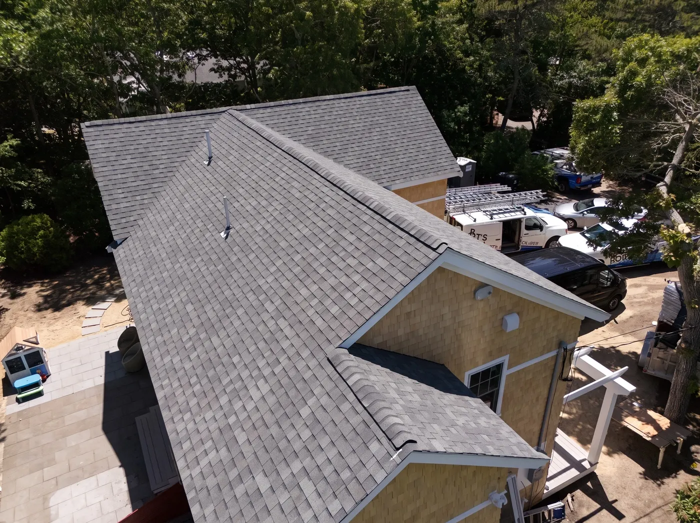 New shingle roof with several gables over cedar shingle walls