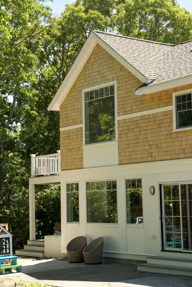 Two-story house finished in new cedar shingle siding with white trim